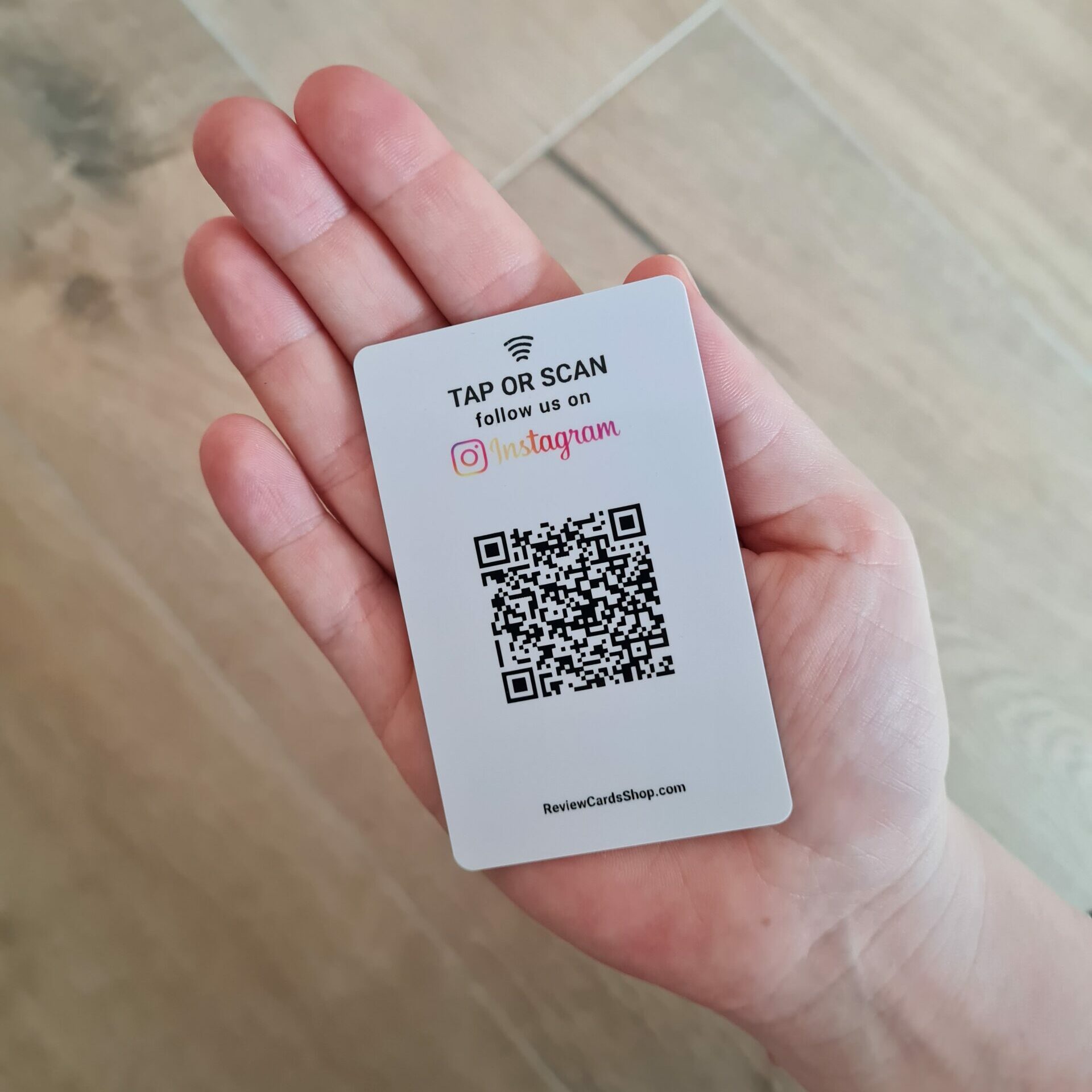 instagram follow us card with nfc and qr in hand