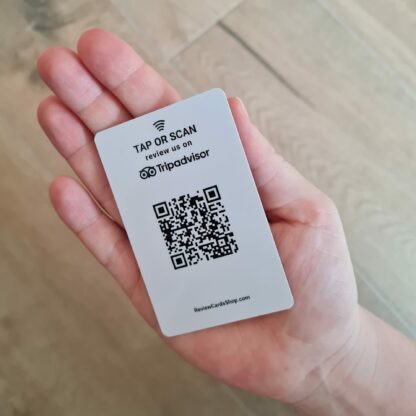 tripadvisor review card with nfc and qr in hand
